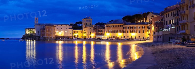 Town beach in the bay Baia del Silenzio with Chiesa di San Nicolo church