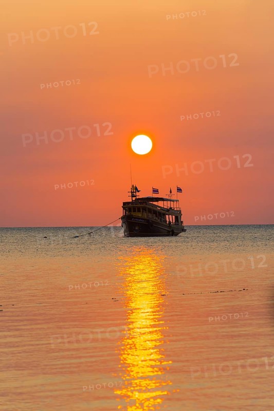 Boat in the sea at sunset