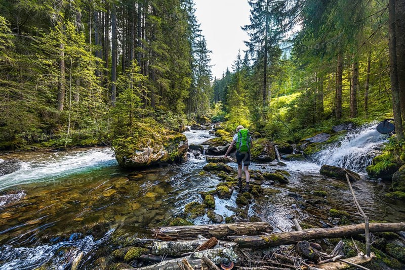 Hiker walking along a river