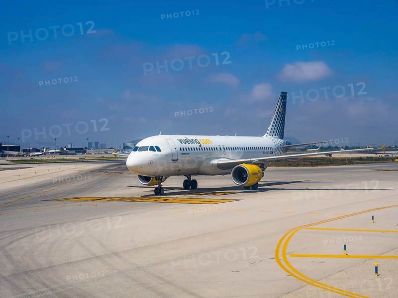 Vueling airliner rolling on the apron of the airport