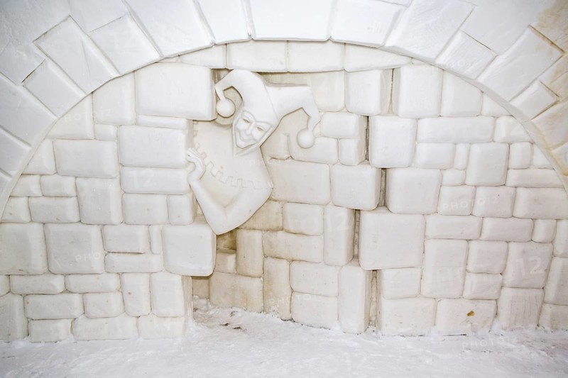 Wall relief of a jester in the ice hotel