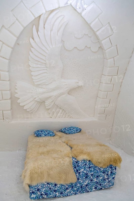 Bedroom with wall decoration relief of an eagle in the ice hotel