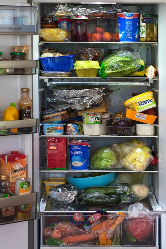 Crammed refrigerator with various foods