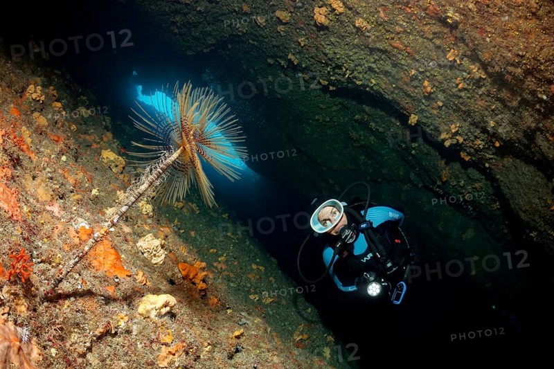 Diver in a cave with lamp
