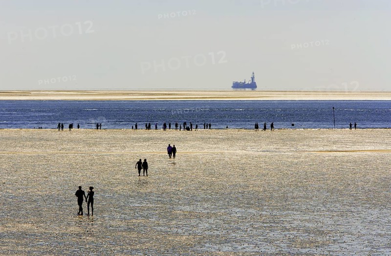 Strollers walking at low tide on the foreshore