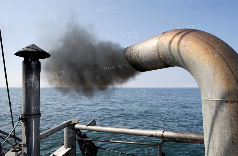 Trawler on a fishing trip with a dark marine diesel smoke cloud
