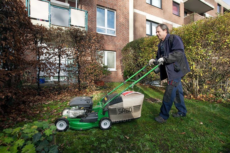Janitor with mowing lawn lawnmower