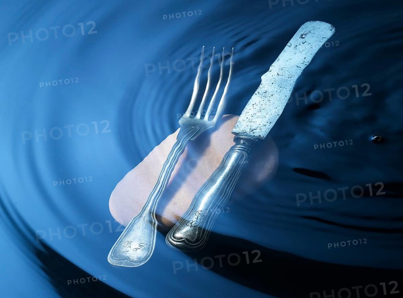 Cutlery on a stone under water