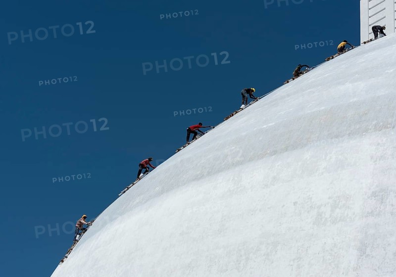 A group of climbers paint Ruwanwelisaya or Ruwanweli Maha Seya Stupa