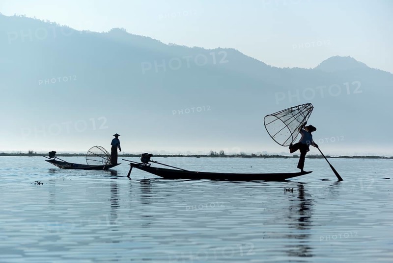 Intha fisherman fishing with traditional conical fishing net