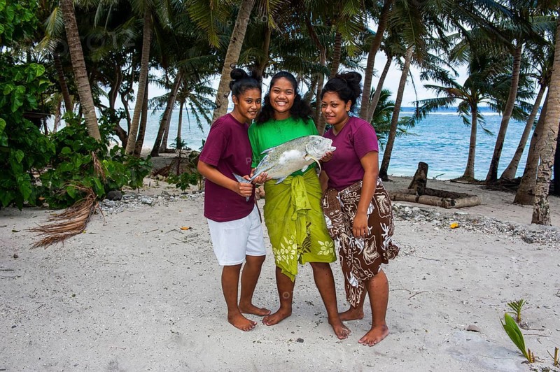 Samoan girls holding their fresh catch