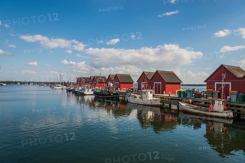 Red cottage with fishing boats