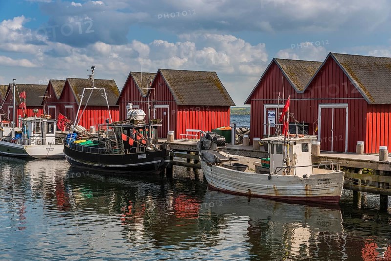 Red cottage with fishing boats