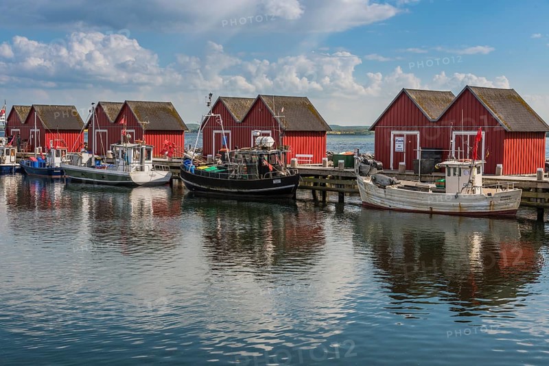 Red cottage with fishing boats