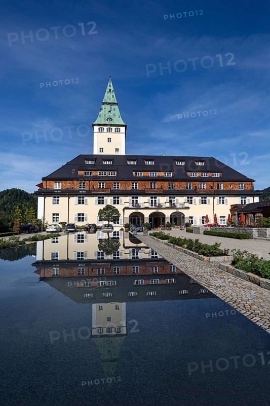 Schloss Elmau castle hotel with tower reflected in the fountain