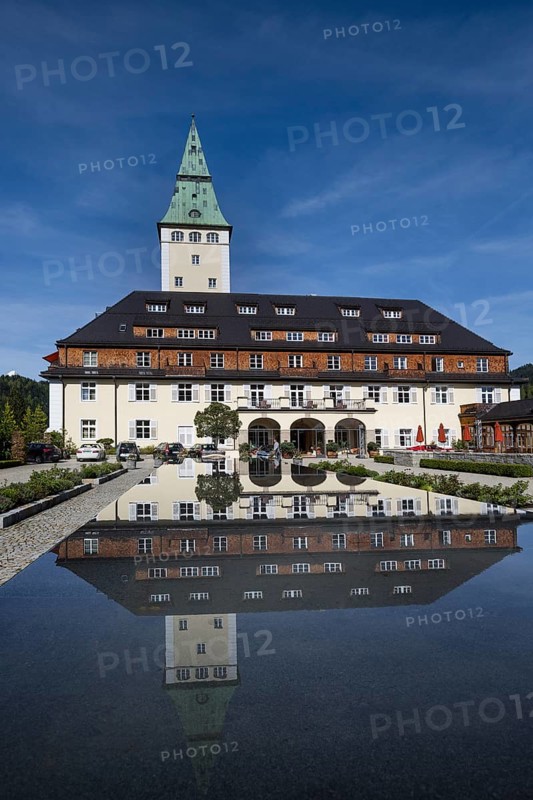 Schloss Elmau castle hotel with tower reflected in the fountain