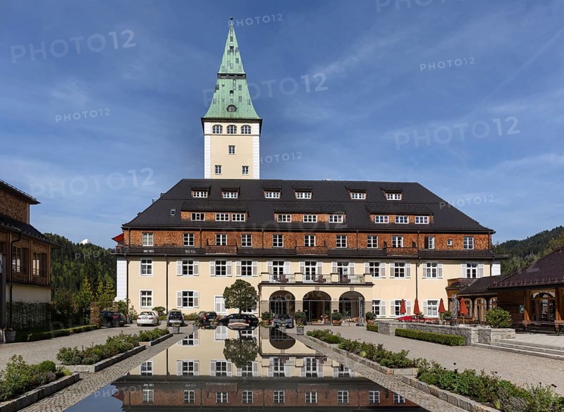 Schloss Elmau castle hotel with tower reflected in the fountain