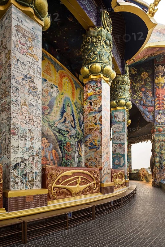 Columns with ceramic images in the gallery of the Elephant Temple Thep Wittayakhom Vihara