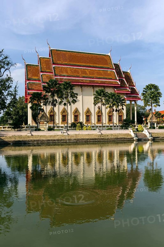 South facade of the Wat Klang temple reflected in a pond