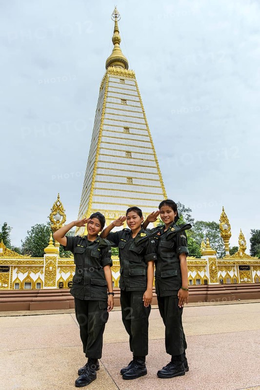 Female soldiers of the Thai Army in front of stupa in Wat Phra That Nong Bua