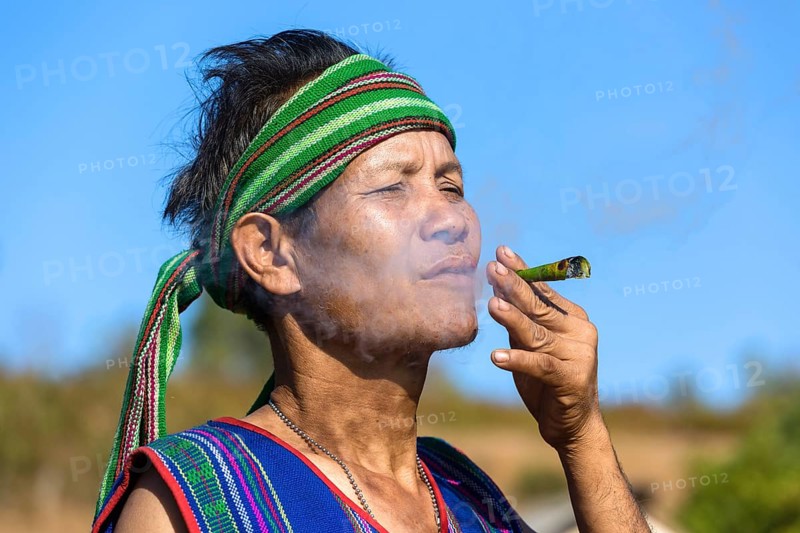 Man in traditional costume smoking cigar