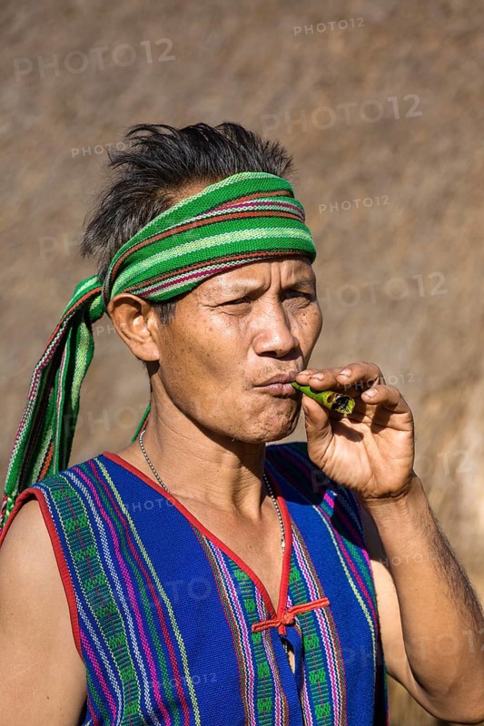 Man in traditional costume smoking cigar