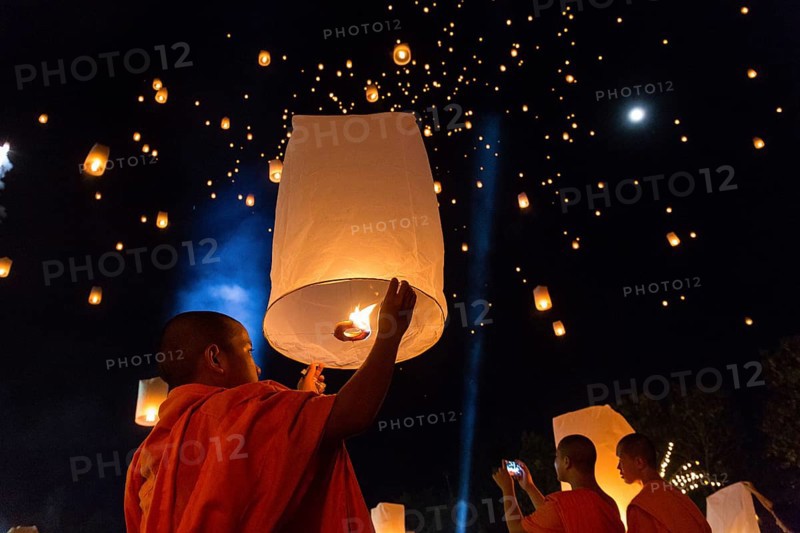 Monk letting sky lantern rise