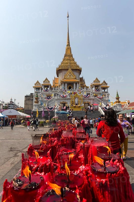 Row of candles at the Phra Maha Mondop of the Wat Traimit temple
