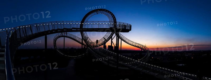Power plant with part of the Tiger and Turtle sculpture at sunset