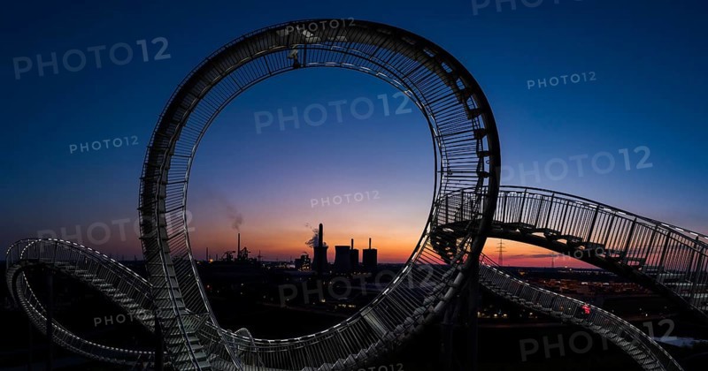 Power plant with part of the Tiger and Turtle sculpture at sunset