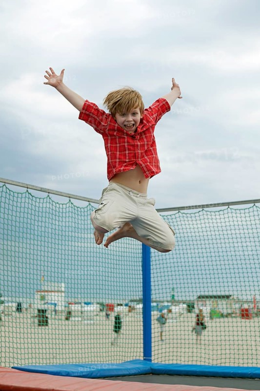 Boy jumping on trampoline