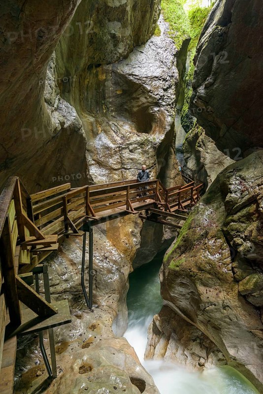 Wooden boardwalk in gorge with stream