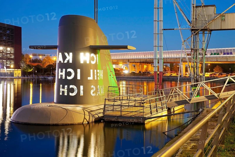 Work of art submarine island at the Kuppersmuhle Museum at dusk