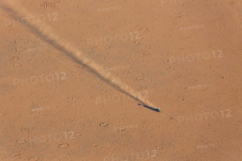 A vehicle of the balloon ground crew crossing a sandy plain at the edge of the Namib Desert