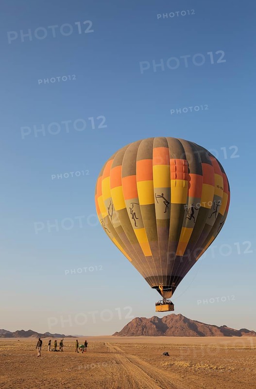 Hot-air balloon just taken-off in the early morning