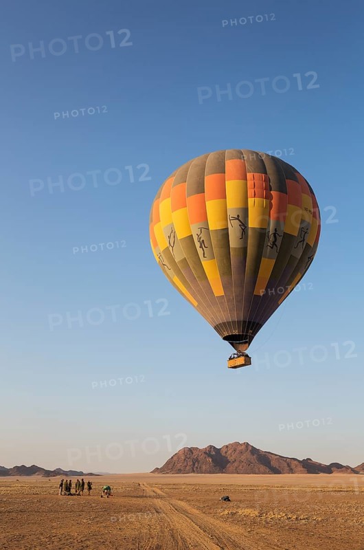 Hot-air balloon just taken-off in the early morning