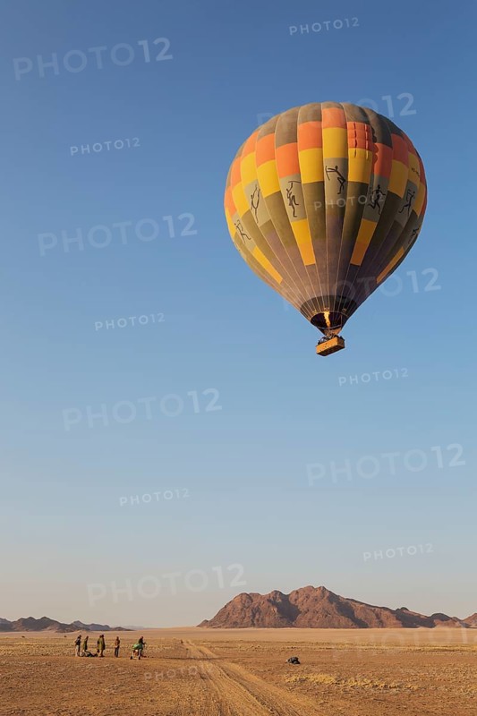 Hot-air balloon just taken-off in the early morning