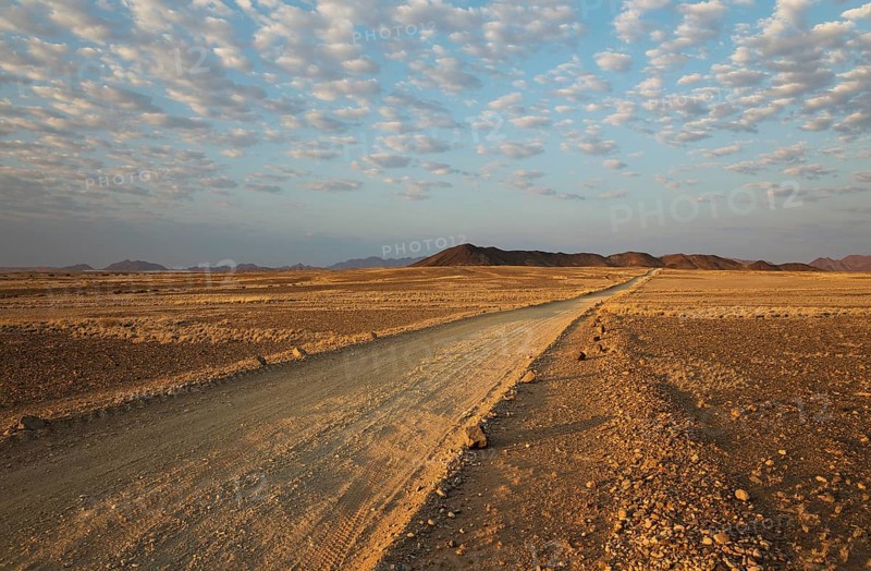 Gravel road on arid plain
