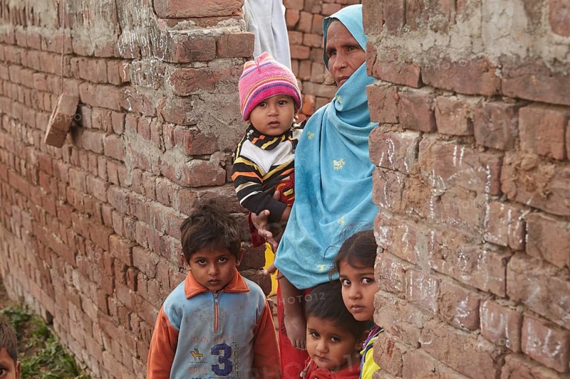 Mother with children living in a brickyard