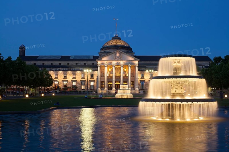 Spa hotel with fountain and park Bowling Green at dusk
