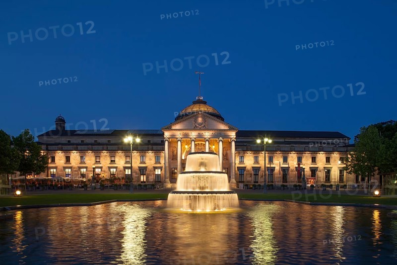 Spa hotel with fountain and park Bowling Green at dusk
