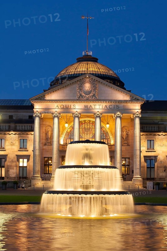 Spa hotel with fountain and park Bowling Green at dusk