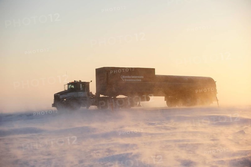 Truck transporting goods on the snowy Dalton Highway in the middle of the Arctic winter
