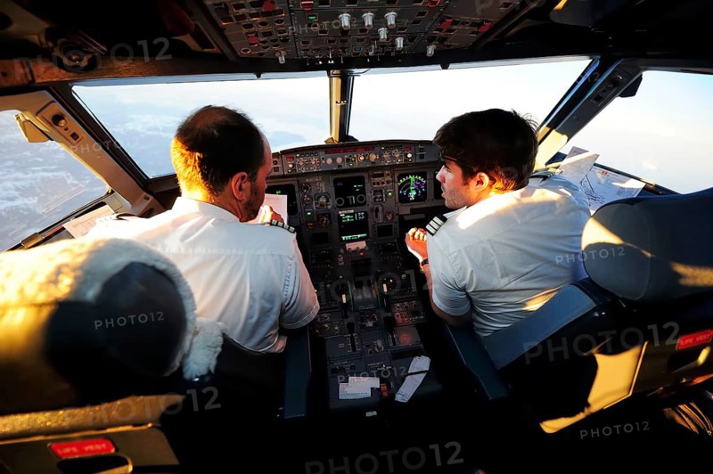 Pilot and copilot in cockpit