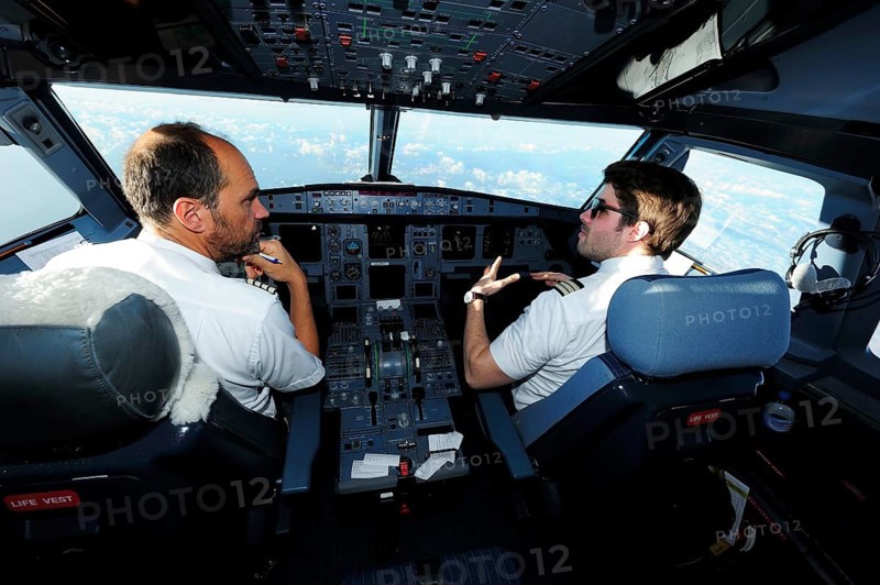 Pilot and copilot in cockpit