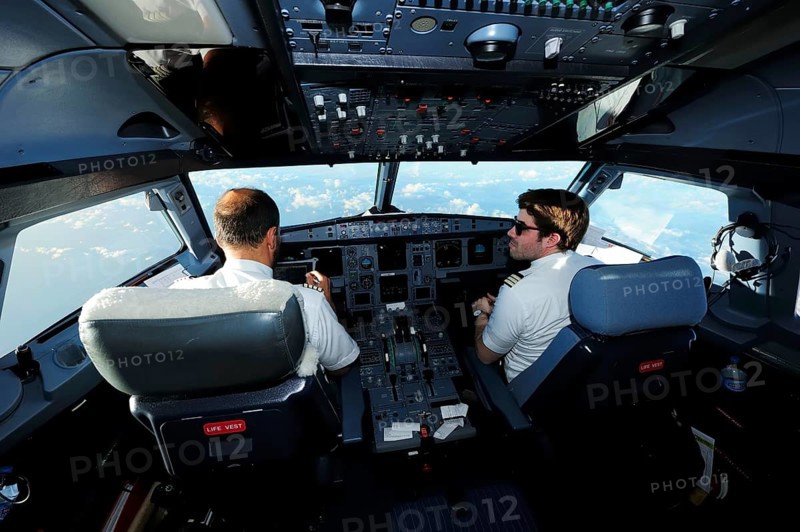 Pilot and copilot in cockpit