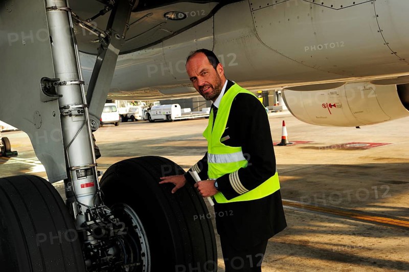 Pilot checking tyres and undercarriage