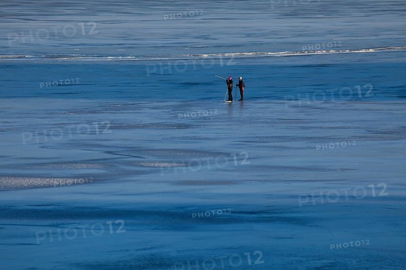 Elderly couple ice skating on frozen Glafsfjorden