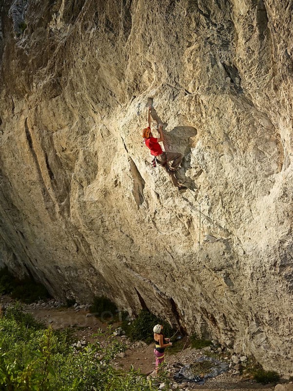 Climber lead climbing on a rock face
