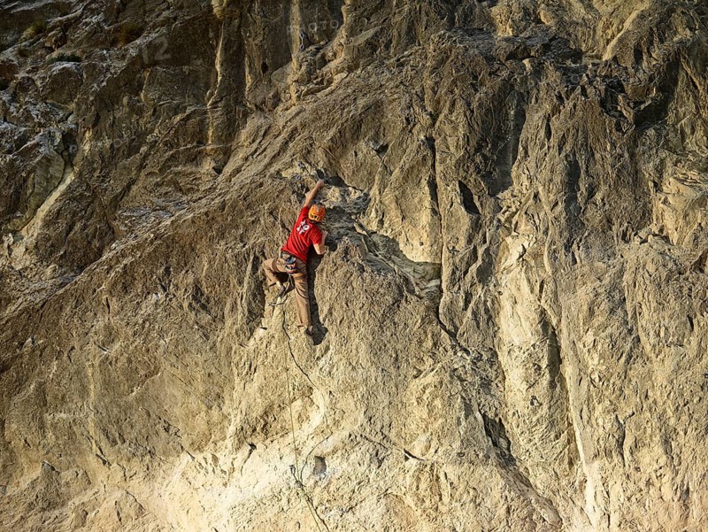 Climber lead climbing on a rock face